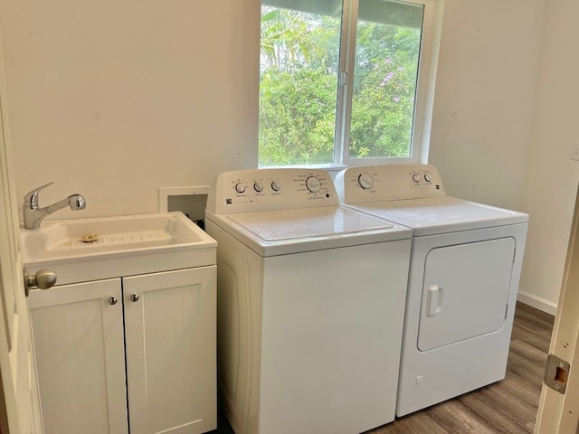 laundry room featuring washer hookup, washing machine and clothes dryer, light hardwood / wood-style flooring, and sink