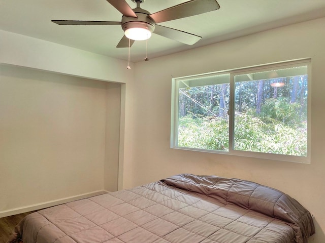 unfurnished bedroom featuring ceiling fan and light wood-type flooring