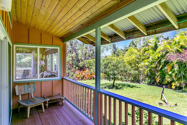 wooden terrace featuring a lawn