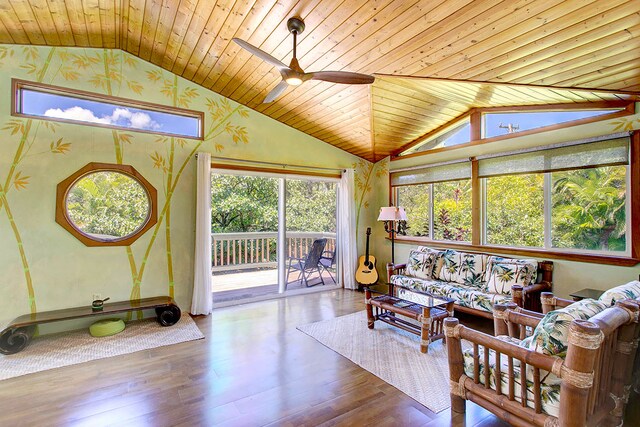 sunroom with lofted ceiling, wooden ceiling, and ceiling fan