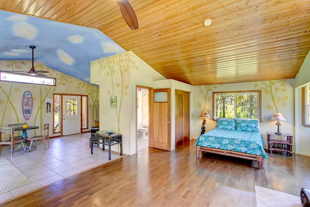 bedroom with wood ceiling, light wood-type flooring, ensuite bathroom, and vaulted ceiling