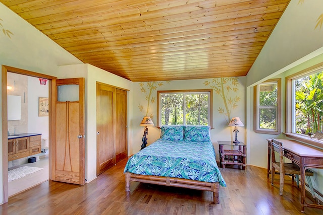 bedroom with dark hardwood / wood-style flooring, wood ceiling, ensuite bath, and vaulted ceiling