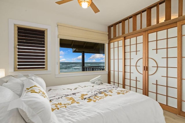 bedroom with ceiling fan and light hardwood / wood-style floors