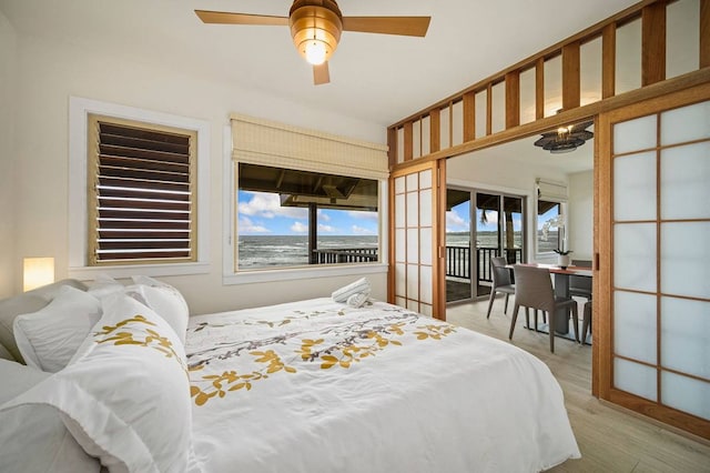 bedroom featuring access to outside, ceiling fan, and light hardwood / wood-style flooring