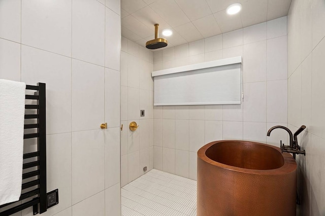 bathroom featuring separate shower and tub, tile walls, and radiator heating unit