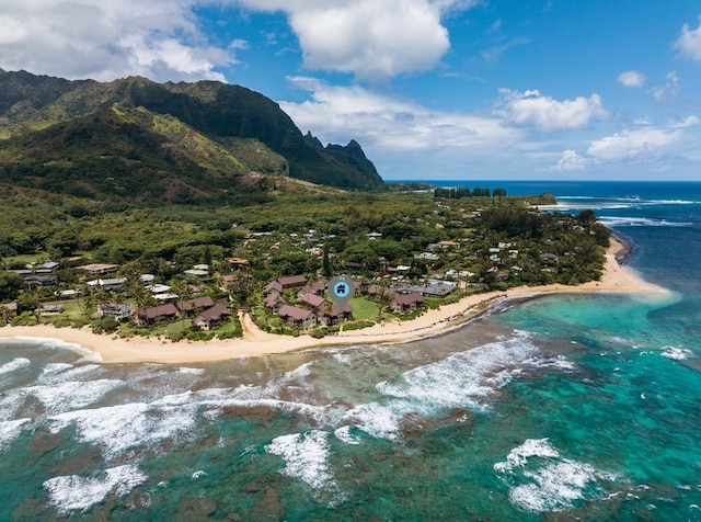 aerial view featuring a water and mountain view and a view of the beach