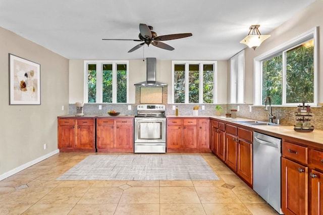 kitchen with appliances with stainless steel finishes, backsplash, wall chimney range hood, and a wealth of natural light