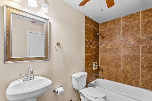 full bathroom featuring toilet, sink, and tiled shower / bath