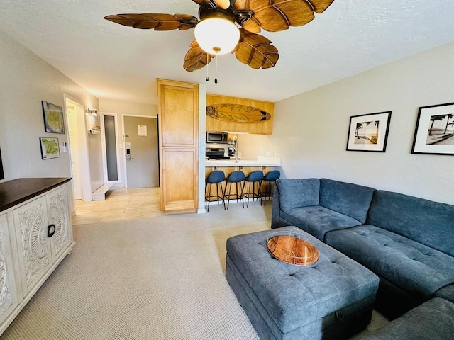 living room featuring ceiling fan and light carpet