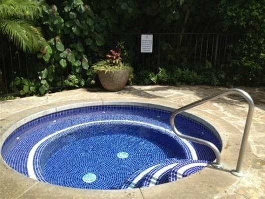 view of pool with a patio area and a hot tub