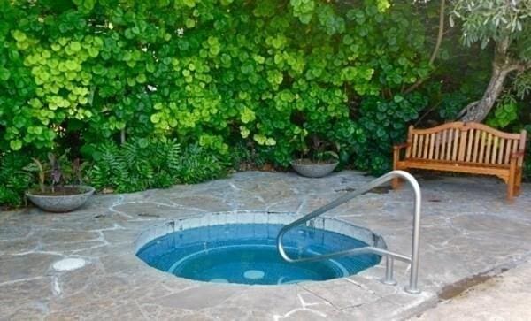 view of swimming pool featuring an in ground hot tub and a patio area