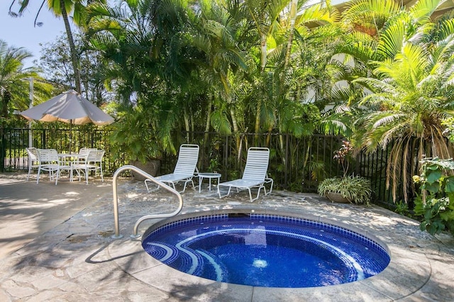 view of swimming pool with a patio and an in ground hot tub