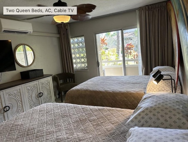 bedroom with ceiling fan and an AC wall unit