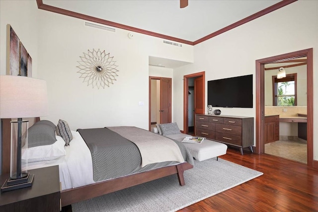 bedroom featuring dark hardwood / wood-style flooring and ensuite bathroom