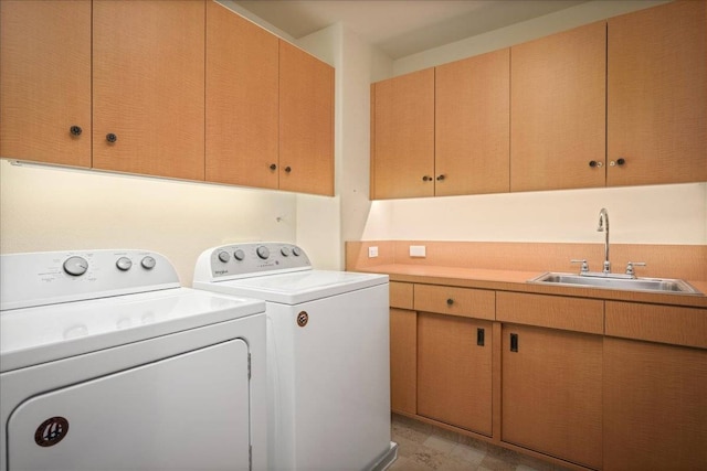 clothes washing area featuring cabinets, separate washer and dryer, and sink