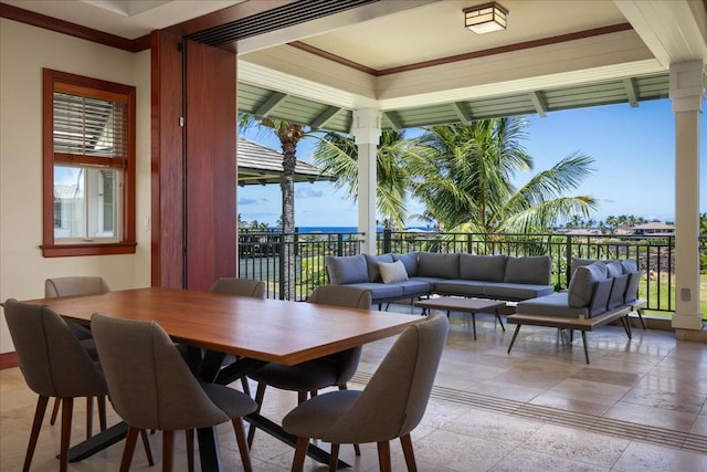 dining room featuring a water view and ornate columns