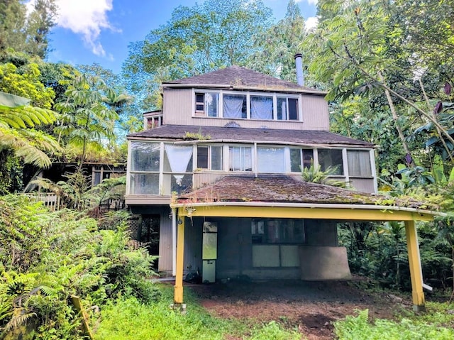 back of house featuring a sunroom