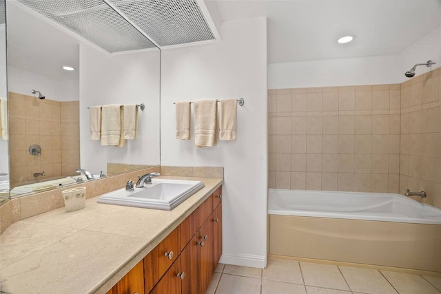 bathroom featuring tiled shower / bath combo, tile flooring, and vanity