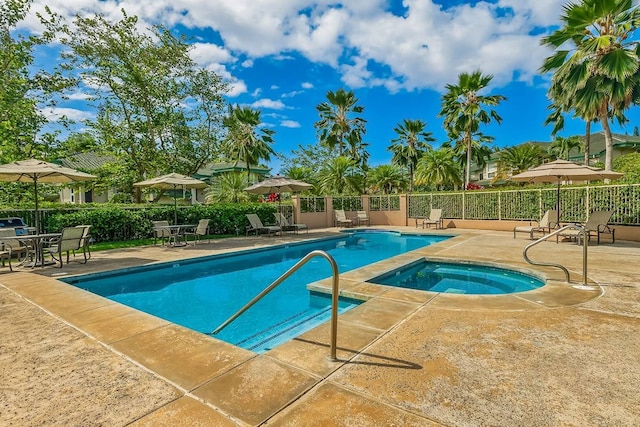 view of swimming pool featuring a patio area and an in ground hot tub