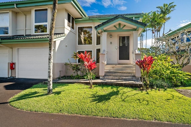 view of front of property with a front lawn and a garage