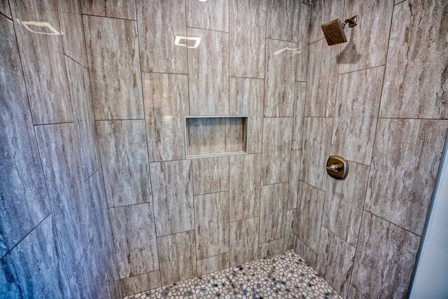 bathroom with a tile shower