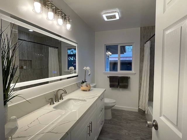 full bathroom featuring shower / bath combination with curtain, toilet, hardwood / wood-style flooring, and vanity with extensive cabinet space