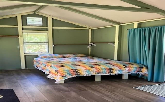 bedroom with dark wood-type flooring and lofted ceiling