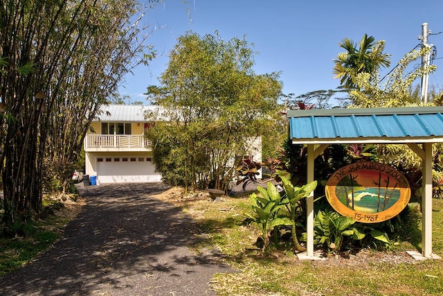 exterior space with a balcony and a garage