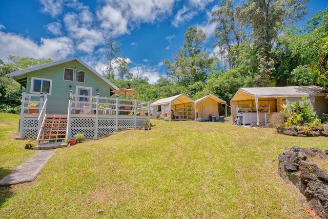 view of yard featuring a wooden deck and an outdoor structure