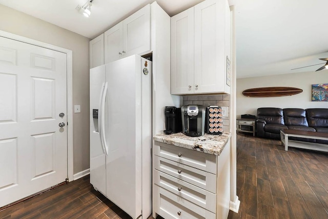 kitchen with ceiling fan, track lighting, white fridge with ice dispenser, white cabinets, and dark hardwood / wood-style flooring