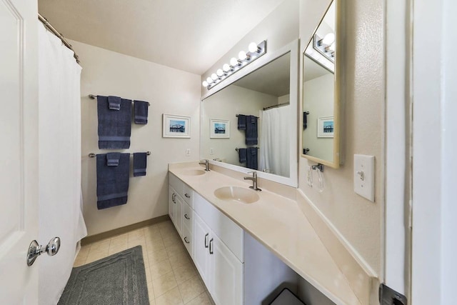 bathroom with double sink, tile flooring, and large vanity