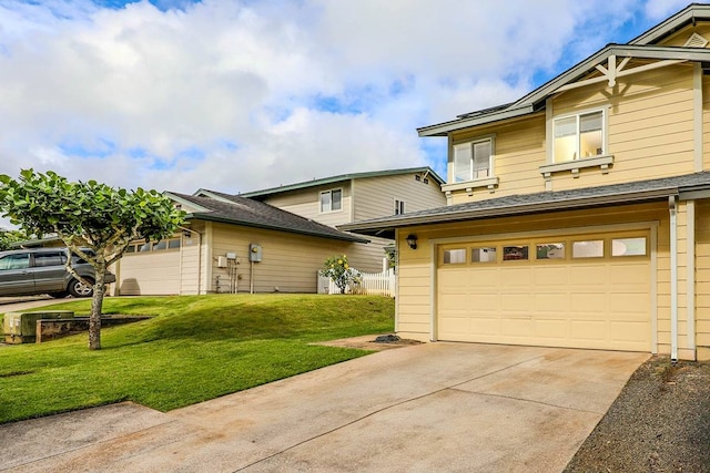 view of front of house featuring a front yard and a garage