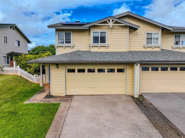 view of front of house featuring a front lawn and a garage