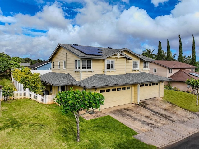 view of front facade featuring solar panels, a front yard, and a garage