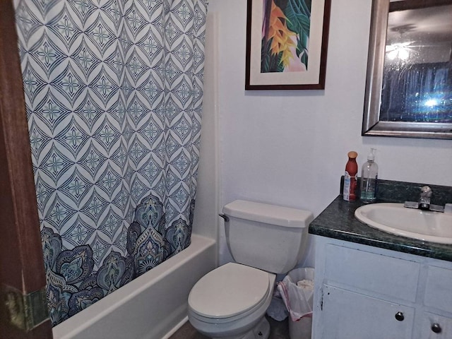 full bathroom with shower / bath combo with shower curtain, toilet, and vanity