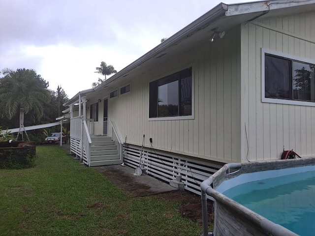 view of side of property with a lawn