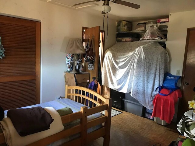 bedroom with ceiling fan and parquet floors