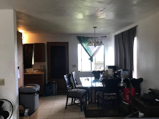 dining room featuring an inviting chandelier and light tile floors