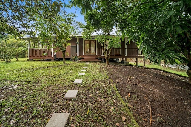 view of yard featuring french doors and a wooden deck