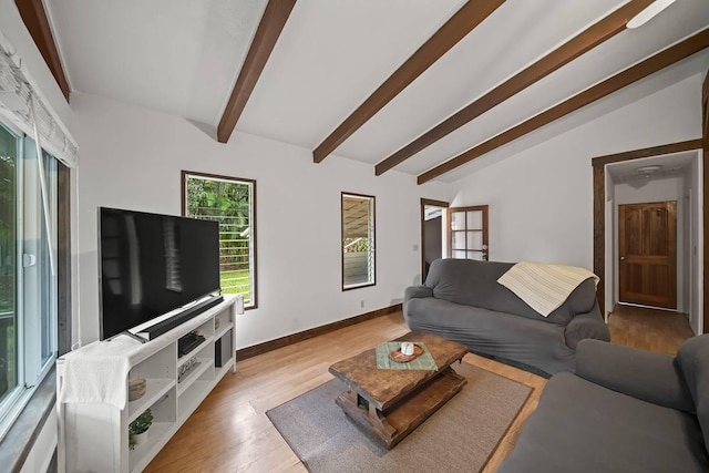 living room with lofted ceiling with beams and light hardwood / wood-style floors