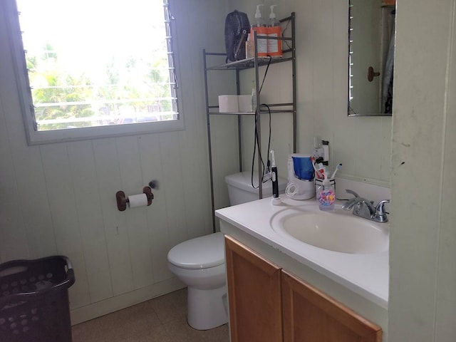 bathroom featuring tile floors, vanity with extensive cabinet space, and toilet