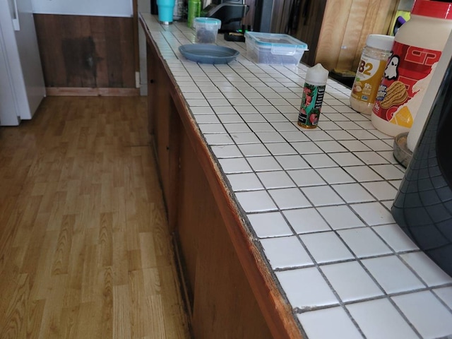 kitchen featuring tile counters and light wood-type flooring