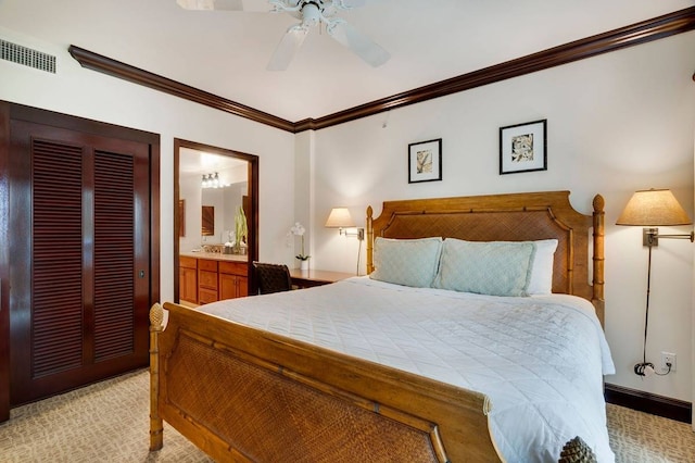 carpeted bedroom featuring ensuite bath, ceiling fan, and ornamental molding