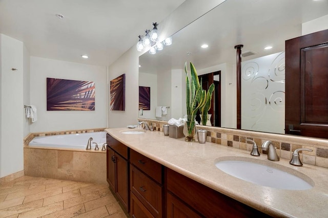 bathroom with oversized vanity, double sink, tasteful backsplash, a relaxing tiled bath, and tile floors