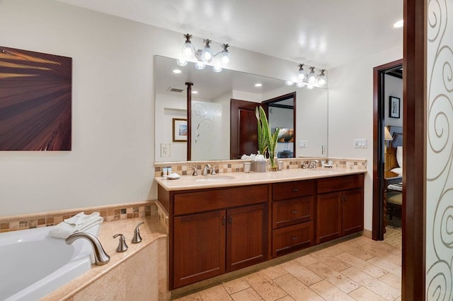 bathroom with dual bowl vanity, tile flooring, and tiled tub