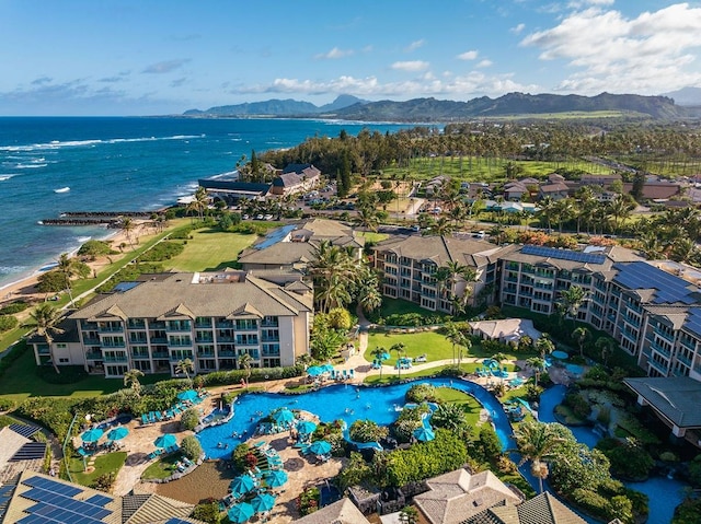 birds eye view of property with a water and mountain view