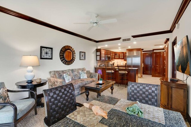 carpeted living room with crown molding and ceiling fan