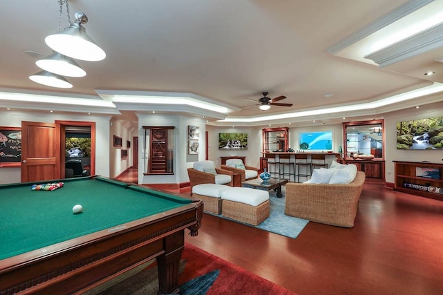 playroom with billiards, dark wood-type flooring, crown molding, ceiling fan, and a tray ceiling