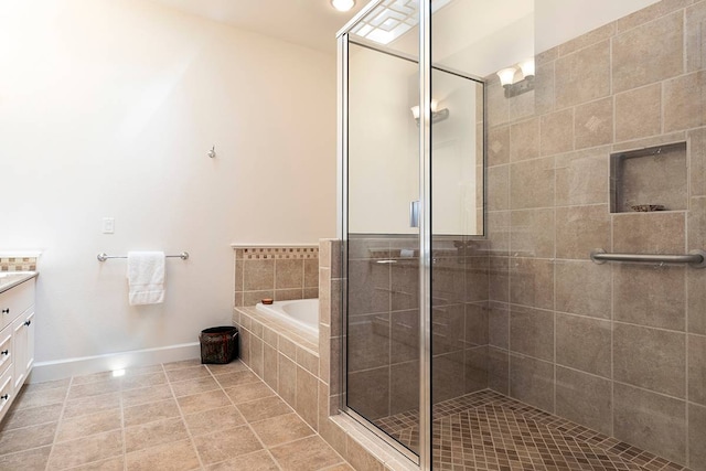 bathroom featuring shower with separate bathtub, tile flooring, and vanity