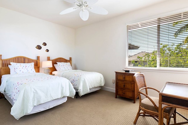 bedroom with light carpet, multiple windows, and ceiling fan